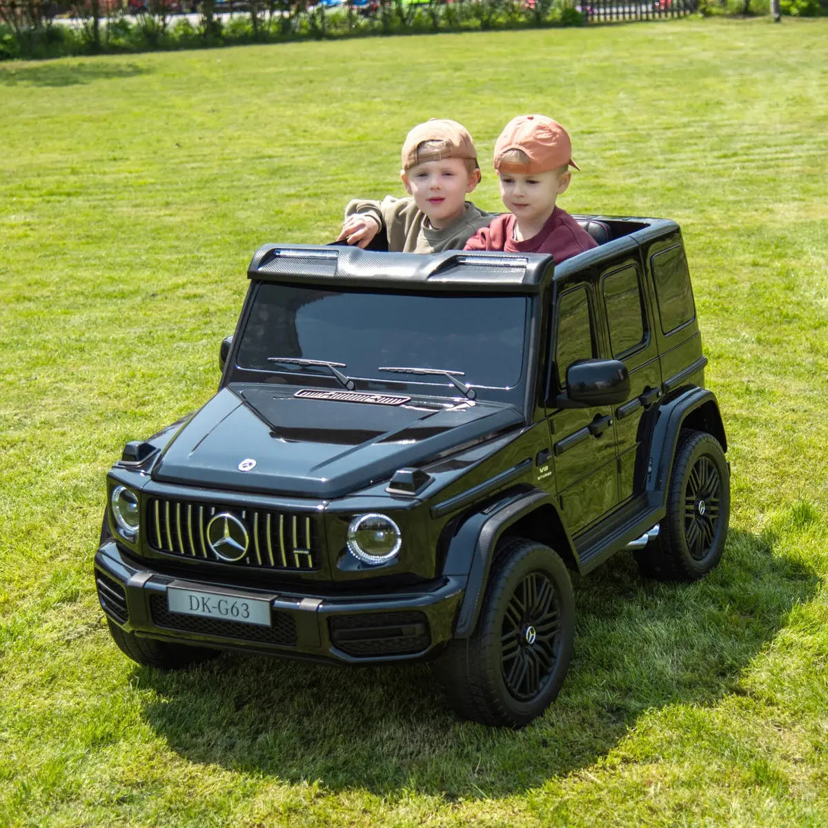 Two kids in a licensed Mercedes G-Wagon ride-on